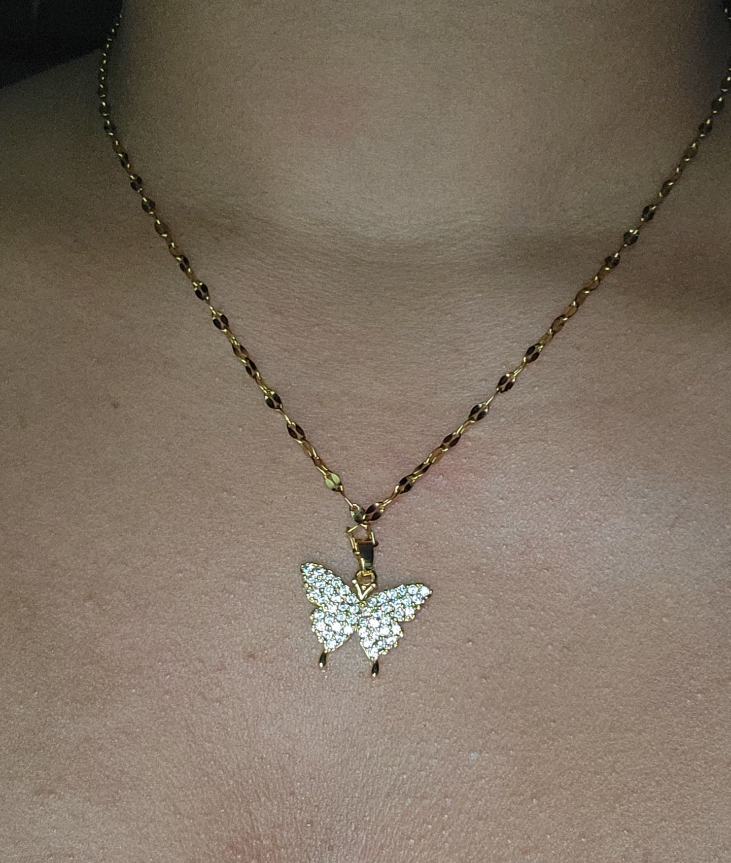 Crystal butterfly pendant necklace in gold plating.