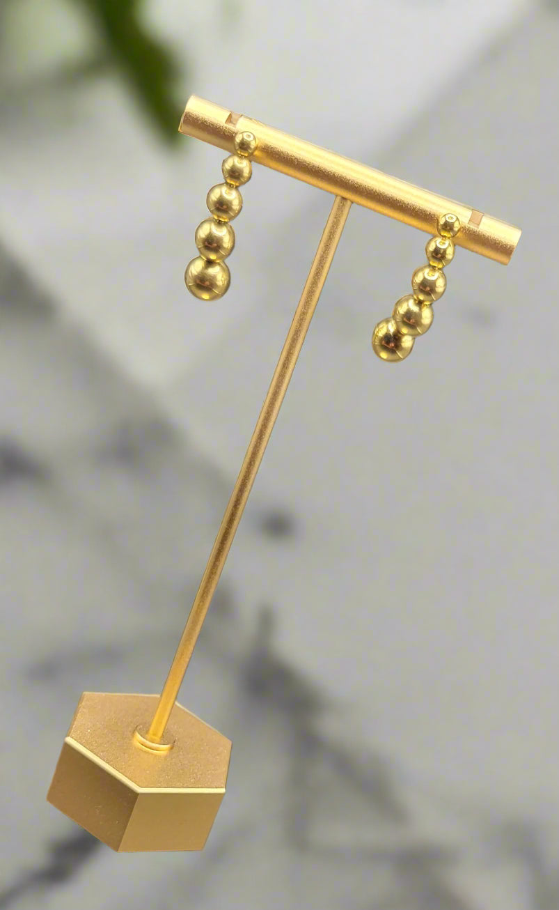 A pair of 18k gold plated stud earrings with a sculptural and organic shape, polished finish.