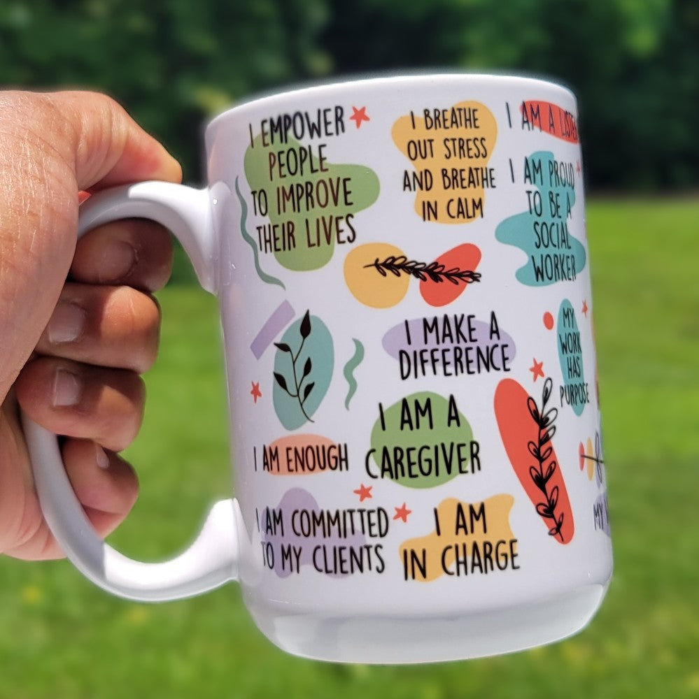 White mug with motivational phrases and colorful illustrations