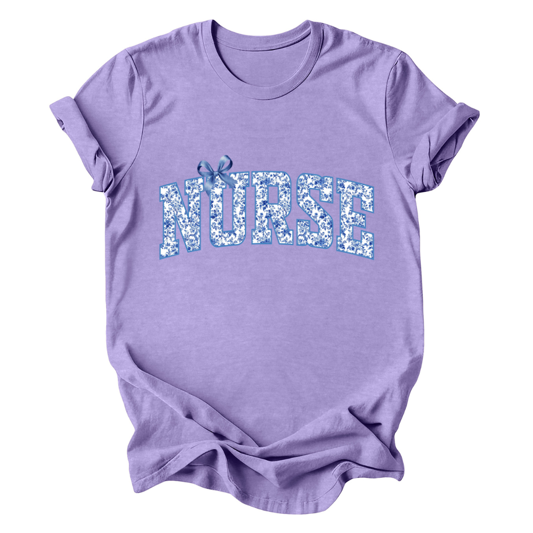 Purple t-shirt with 'NURSE' printed in blue floral letters on a white background