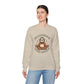 Woman wearing a beige sweatshirt with a sloth graphic and text on a white background