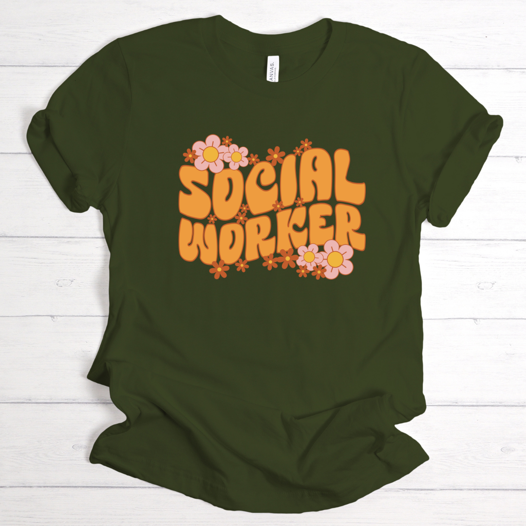 Green t-shirt with 'Social Worker' text and floral designs on a white wooden background