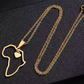 A gold necklace with a pendant in the shape of Africa's map, featuring a heart symbol on the continent's center.